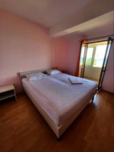 a large bed in a room with a window at Apartment Prvic Sepurine in Prvić Šepurine