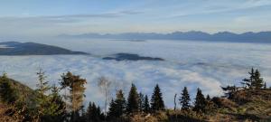 une vue au-dessus des nuages dans les montagnes dans l'établissement Familien-Garten-Suite Kanzelhöhe Gerlitzen - gerlitzenurlaub at, à Kanzelhöhe