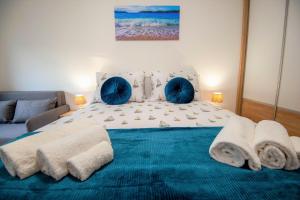 a bedroom with a large bed with towels on it at My Adriatic Suite with private garden in Šibenik