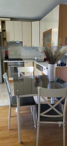 a kitchen with a table with a vase on it at Apartments Maja in Split