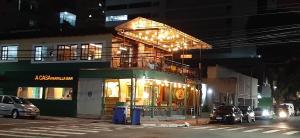 um edifício com um restaurante numa rua da cidade à noite em Lindo Ap Praia da Costa com Ar Condicionado em Vila Velha