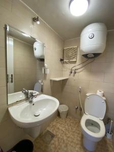 a bathroom with a sink and a toilet and a mirror at (AB By The River) Apartment 801 With Great View in Cairo