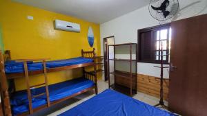 a room with three bunk beds and a window at Bardul´s House in Ubatuba