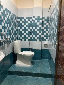 a bathroom with a toilet and a sink at Hotel City View in Bhubaneshwar +12 photos