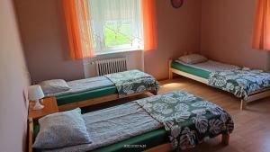 Katil atau katil-katil dalam bilik di Pokoje Gościnne JAK W DOMU Hanna Kucharska