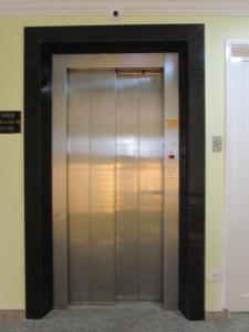 a elevator in a building with its door open at Hotel Monteneve in São Paulo