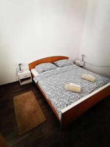 a bedroom with a large bed with two pillows at Apartman ViL in Sveti Vid-Miholjice