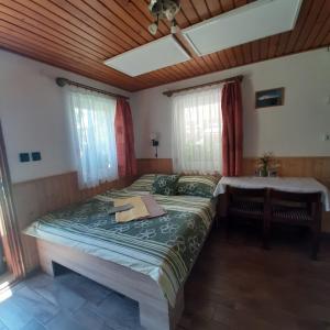 A bed or beds in a room at Rózsa Vendégház