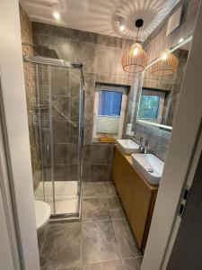 a bathroom with a shower and a toilet and a sink at Norda Resort in Dębki
