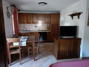 a kitchen with a small table and a television at Lo PONTON in Introd
