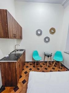 a kitchen with two chairs and a sink and a table at Apartments Tumanyan in Yerevan