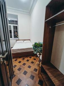 a bedroom with a bed and a window and a door at Apartments Tumanyan in Yerevan