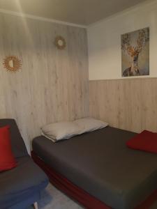 a bedroom with two beds and a chair in it at STUDIO ENTRE PARIS et DISNEY 2 in Torcy