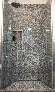 a shower with a glass door in a bathroom at U'Panare in Taranto
