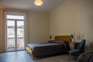 a bedroom with a bed and a large window at U'Panare in Taranto