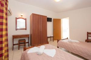a hotel room with two beds and a mirror at PAHNIS studios in Alikanas