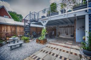 a patio with a staircase and a table and bench at Hus Tidevann in Tönning