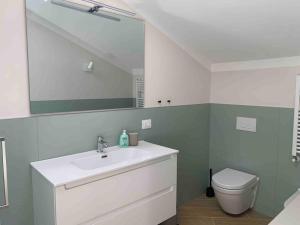 a bathroom with a sink and a toilet and a mirror at Boutique Apartment - Tropea in Tropea +24 photos