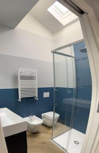 a bathroom with a toilet and a glass shower at Boutique Apartment - Tropea in Tropea
