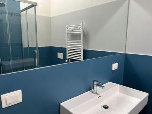 a bathroom with a sink and a mirror at Boutique Apartment - Tropea in Tropea