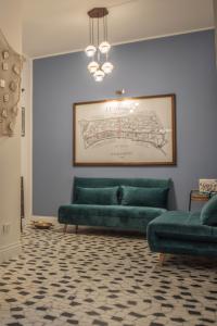 a living room with a green couch and a painting at U'Panare in Taranto