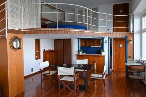 a dining room with a table and a loft bed at LA CASA SULL’ ACQUA in Naples