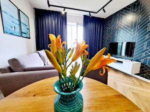 Televízia a/alebo spoločenská miestnosť v ubytovaní Apartament Północne Mazury
