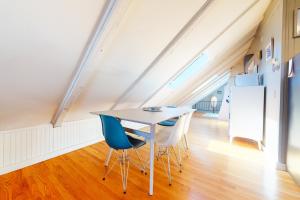 a dining room with a table and chairs in a attic at Monument View in Provincetown