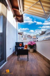 a balcony with a table and a view of a city at La maison di Lea in Gaeta