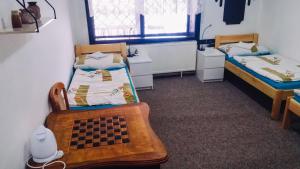 um quarto com duas camas e um tabuleiro de xadrez em Penzion u Karla 