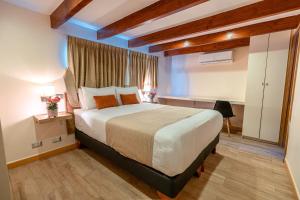 Postel nebo postele na pokoji v ubytování Tagle Hotel Boutique
