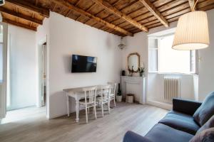 a living room with a table and a couch at Silvia Como House - The House Of Travelers in Como