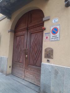 una gran puerta de madera en el lateral de un edificio en Alloggio Torino InQuadro, en Turín