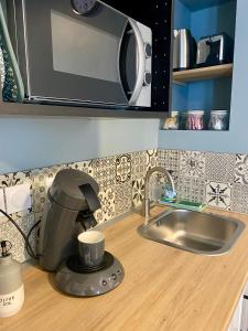 a coffee maker sitting on top of a kitchen counter at Studio ESPRIT COZY in Ballan-Miré