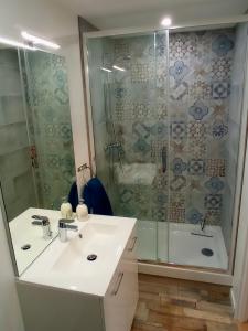 y baño con lavabo blanco y ducha. en Studio ESPRIT COZY, en Ballan-Miré