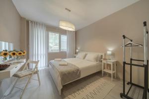 a bedroom with a bed and a table and a desk at WILLY-ANDON APARTMENT in Varna City