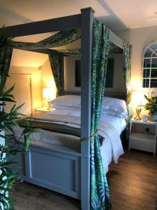 a bedroom with a four poster bed with a canopy at The Nest Danehill in Haywards Heath