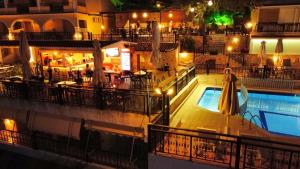 a hotel pool with a bar and a restaurant at Zante Palace in Tsilivi