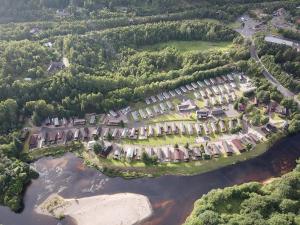 an aerial view of a resort complex next to a river at Feorag Lodge in Aviemore