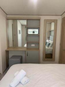 a bedroom with a large mirror and a bed at Feorag Lodge in Aviemore