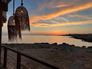 a chandelier with the sunset in the background at Monolocale Cora in Corsano