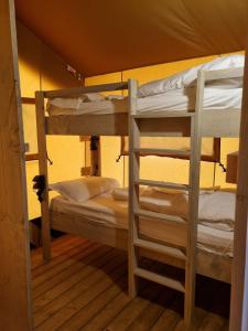 A bed or beds in a room at Glamping Le Tegole