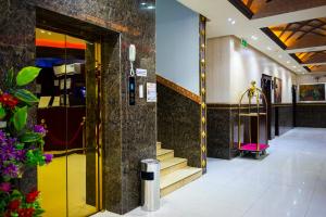 a lobby of a hotel with a yellow door and stairs at Ahlin Suites 1 By Khaymat Alyarmouk in Riyadh