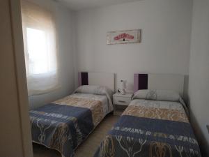 Posteľ alebo postele v izbe v ubytovaní PROALMAR, chalet 17