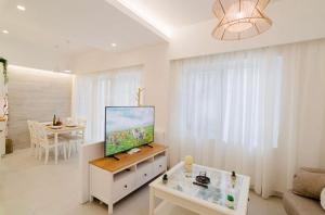 a living room with a flat screen tv on a cabinet at Old town luxury apartment in Kos Town