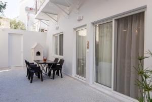 a dining room with a table and chairs on a patio at Old town luxury apartment in Kos