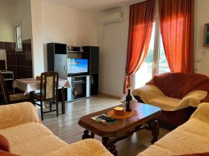 a living room with a couch and a coffee table at Apartments Mujovi in Bar