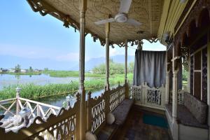 a balcony of a house with a view of a river at Houseboat Zaindari Palace in Srinagar