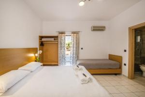 a bedroom with a large bed and a bathroom at SMAROULA in Elafonisi