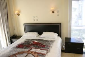 Postel nebo postele na pokoji v ubytování Petit Palais Hotel